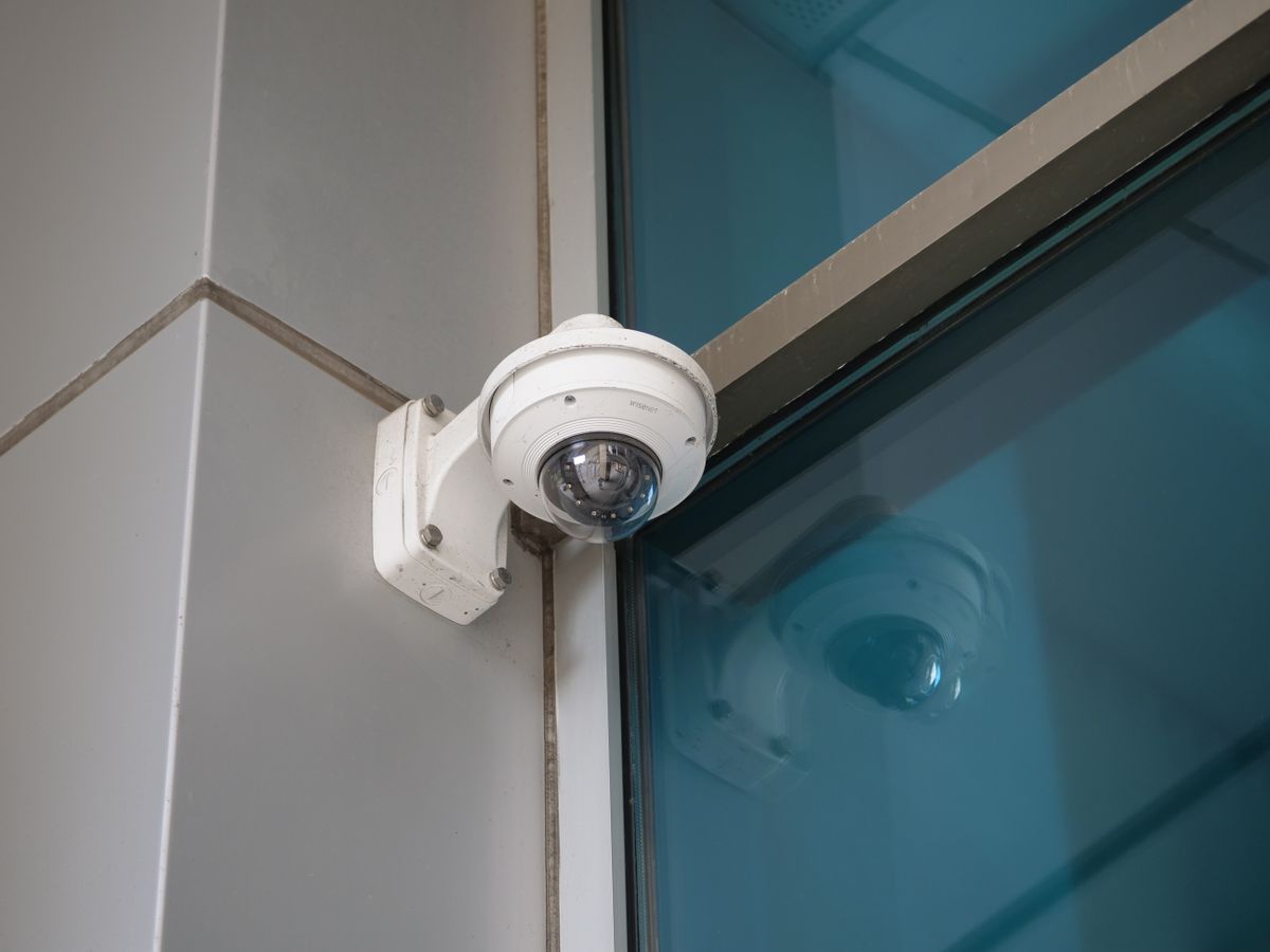 Professionally installed dome security camera mounted on a building corner