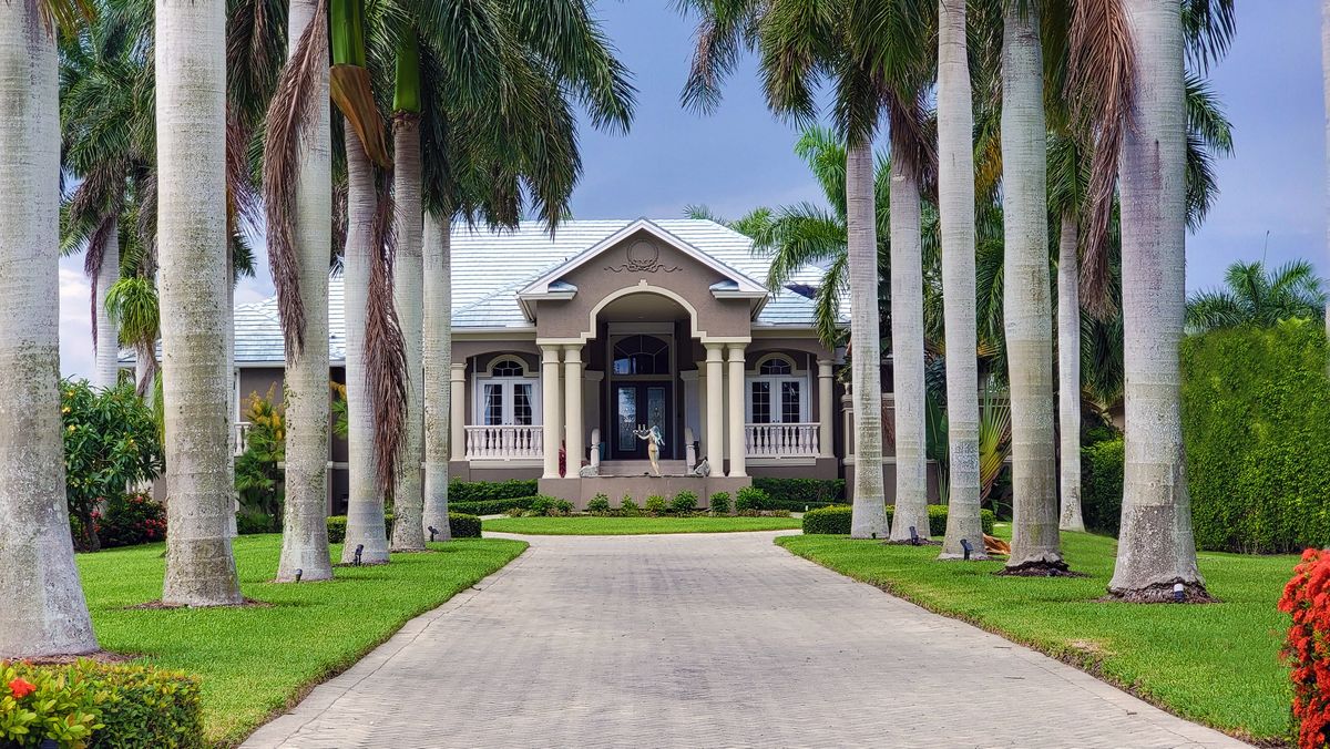 Palm lined driveway approach to a South Florida home, the main vehicle approach a security camera needs to cover
